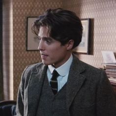 the young man is wearing a suit and tie