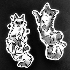 two stickers with cats on them sitting next to each other in black and white
