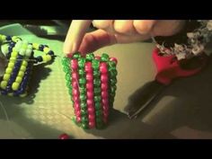 someone is making beaded bracelets out of beads