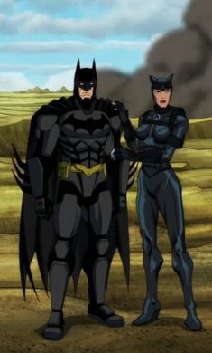 batman and catwoman standing in the desert