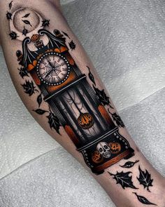 a person with a clock tattoo on their leg and some pumpkins around the ankles