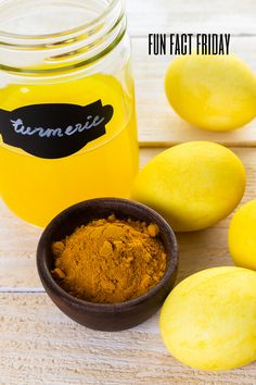 lemons and turment in a bowl next to a jar