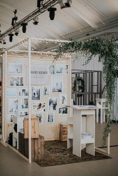 a room with pictures on the wall and plants growing out of it's walls