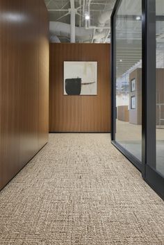 an empty office with wood paneling and glass doors