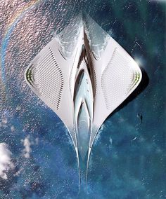 an aerial view of a boat floating in the water with a rainbow behind it and blue sky