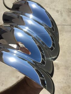 a close up of a person's hand holding a motorcycle helmet