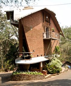 a brick building with a balcony on the top