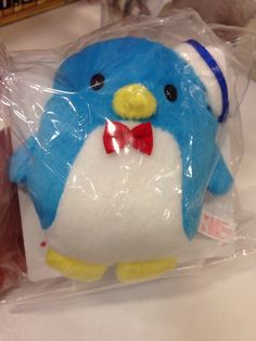 a blue and white stuffed animal with a red bow tie
