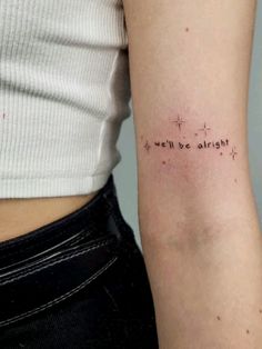 a woman's arm with the words we'll be alright tattooed on it