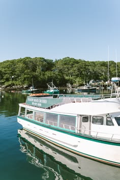 a white boat floating on top of a body of water