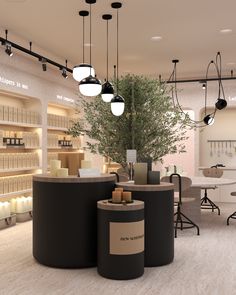 the interior of a cosmetics store with two large round displays and lights hanging from the ceiling