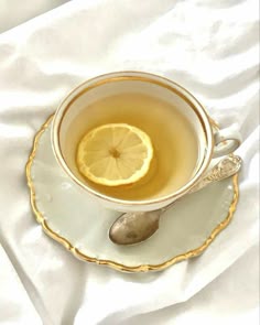 a cup of tea with a lemon slice in it