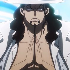 a man with long hair wearing a white hat and holding his hands up to his chest