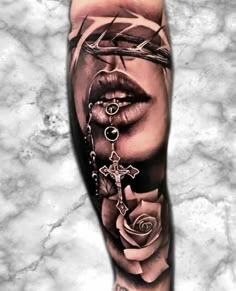 a woman's leg with a cross and roses on it