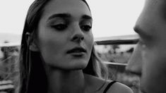black and white photo of woman looking at man