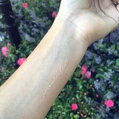 someone is holding up their arm with the word bang bangy on it's wrist