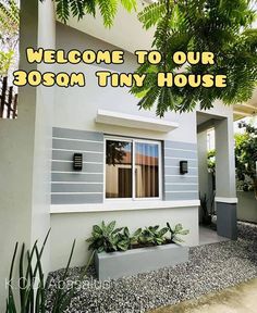 welcome to our boson tiny house with plants in the front yard and trees on either side