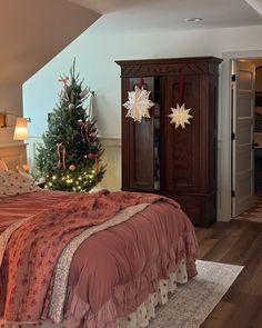 a bedroom with a christmas tree in the corner