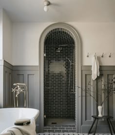 a white bath tub sitting next to a walk in shower