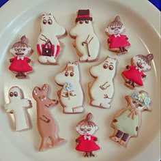 a white plate topped with lots of decorated cookies