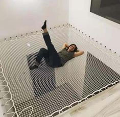 a woman laying on the ground with her legs up in the air and arms out