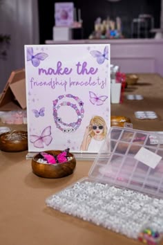 a table topped with lots of jewelry and greeting cards next to donuts on top of it