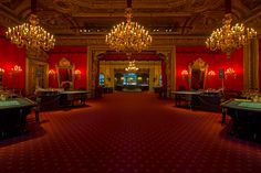 an ornately decorated room with red walls and chandeliers