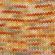 an orange, yellow and grey knitted blanket