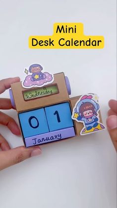 someone is holding up a wooden calendar