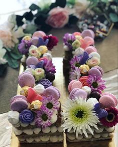 there is a cake decorated with flowers and eggs on top of the letter e,