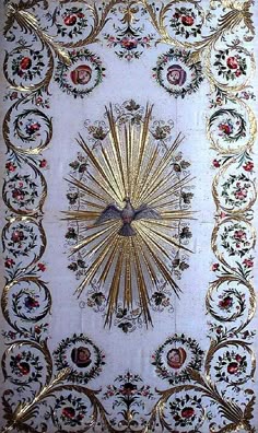 an ornate gold and white wall hanging