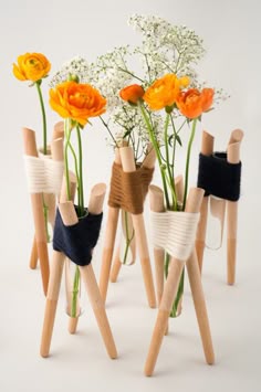 several wooden sticks with flowers in them