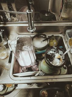 a kitchen sink filled with dirty dishes and utensils