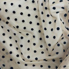 black and white polka dot print fabric with small dots on the top, as seen from above