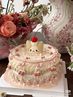 there is a cake on the table with flowers in the background