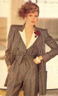 The 1980s power suit became a symbol of womens rights. For the first time women were beginning to be taken seriously in the work environment, and this was the first time they could wear pants. Often the suit had matching jacket and trousers. Additionally the shoulder pads were larger, to sort of give them a bigger, more man-like appearance. Although still feminine, in many ways the women's power suit mirrored that of the mans. Allison Hauke. 4/11/17 Power Dressing In The 80s, 80s Womens Business Suit, Wide Shoulder Suit, 80s Power Dressing, Power Dressing 80s, 80s Power Suit, 70s Power Suit, 80s Powersuit, Striped Suit Women
