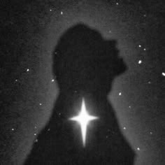 the silhouette of a man with a star in his hand