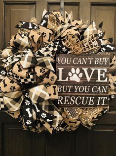 a black and white wreath that says you can't buy love but you can rescue it