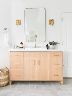 a bathroom with white walls and wooden cabinets