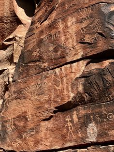 the rock has many petroglyic drawings on it
