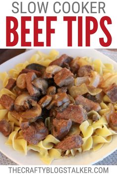 a white plate filled with pasta and meat on top of a table next to the words slow cooker beef tips