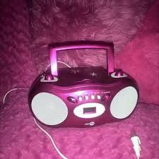 a purple radio sitting on top of a pink couch
