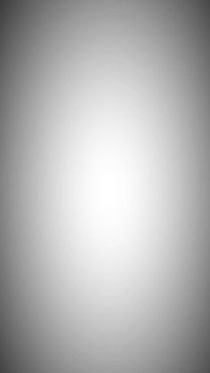 a black and white photo of the sun shining in the foggy sky with no clouds