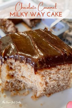 a close up of a piece of cake on a plate with chocolate caramel frosting