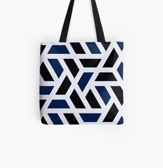 a black and white tote bag with blue geometric shapes on it, against a white background