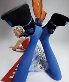 a woman sitting on the ground with her legs spread out in front of her face