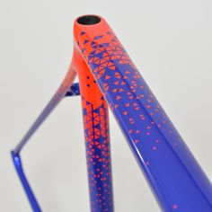 an orange and blue bike frame with designs on it