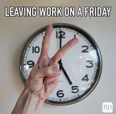 a person making the peace sign with their hand in front of a clock that says leaving work on a friday