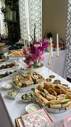 a buffet table with sandwiches and dips on the side at a wedding or bridal party