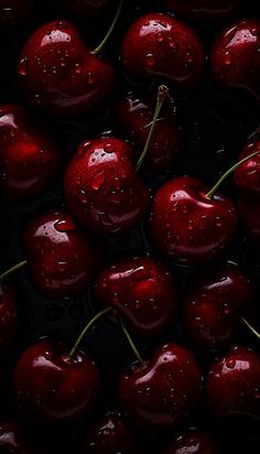 some cherries with water droplets on them